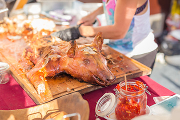 Image showing Roasted suckling pig served on food stall.