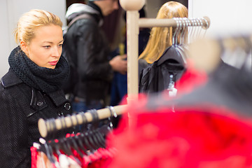 Image showing Beautiful woman shopping in clothing store.