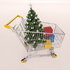 Image showing Shopping cart full of purchases in packages and Christamas tree