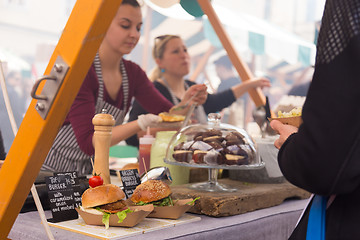 Image showing Women serving hamburgers on food festival in Ljubljana, Slovenia.