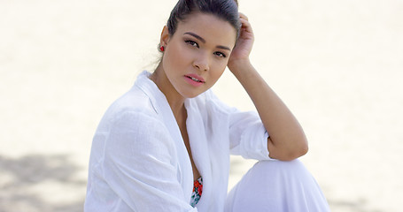 Image showing Charming woman sitting with head resting on hand