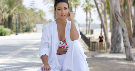 Image showing Calm woman in white robe sitting outdoors