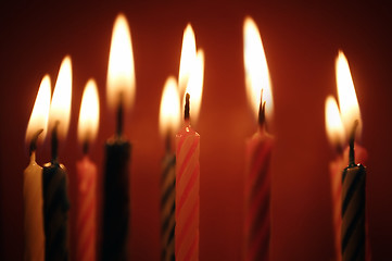 Image showing Closeup of birthday candles all lit.