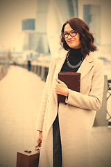 Image showing smiling middle-aged woman with books