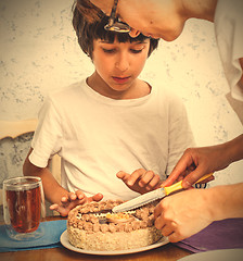 Image showing mom with son cut a birthday cake