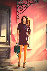 Image showing fashion. beautiful woman in a stylish burgundy dres