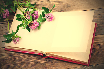 Image showing photo album and clover flowers