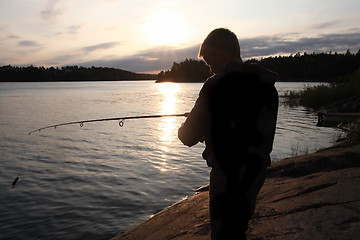 Image showing  Boy Fishing at Sunrise