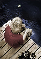 Image showing Boy sitting on a Footbridge