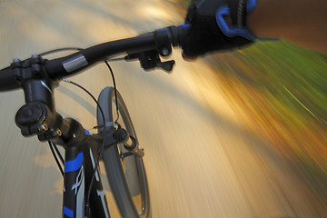 Image showing Fast motion mountain bike on a road