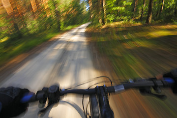 Image showing Fast motion mountain bike on a road