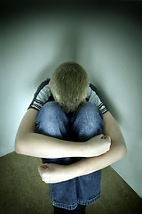 Image showing upset boy against a wall