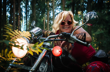 Image showing Mature woman biker on a motorcycle