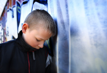 Image showing upset boy against a wall