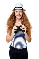 Image showing Female looking through binoculars