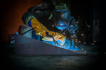 Image showing worker welding metal