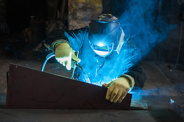 Image showing worker welding metal