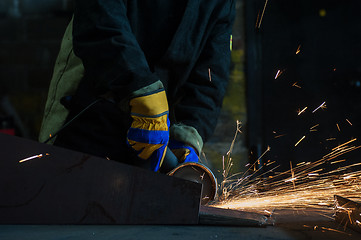 Image showing worker welding metal