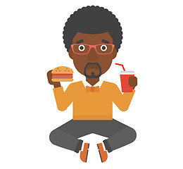 Image showing Man eating hamburger. 