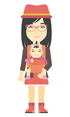 Image showing Woman holding baby in sling.