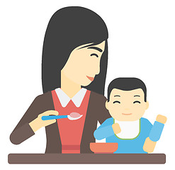 Image showing Woman feeding baby.