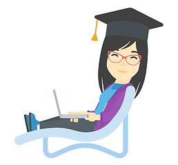 Image showing Graduate lying in chaise lounge with laptop.