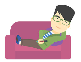 Image showing Man sitting on the couch with remote control.