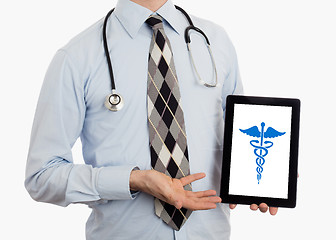 Image showing Doctor holding tablet - Caduceus symbol