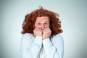 Image showing The young frightened man looking at camera