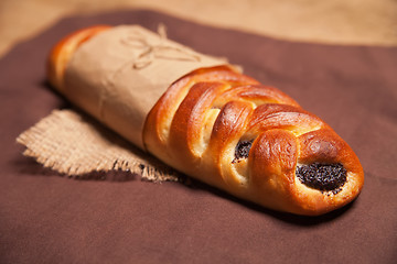 Image showing Poppy roll on brown napkin