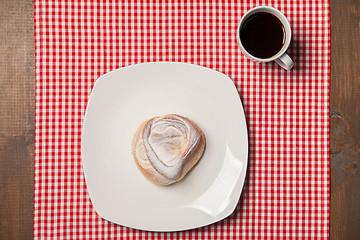 Image showing Coffee and sweet cupcake on checkered napkin