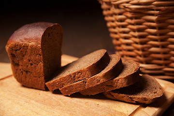 Image showing Sliced rye bread and basket closeup