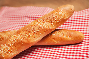 Image showing French bread isolated on checkered napkin