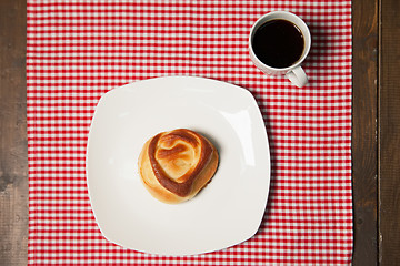 Image showing Coffee and sweet cupcake on checkered napkin