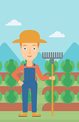 Image showing Farmer with rake.