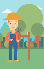 Image showing Farmer with pruner in garden.