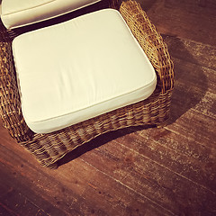 Image showing Retro style rattan armchair on wooden floor