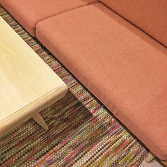 Image showing Salmon color sofa and wooden coffee table