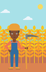 Image showing Farmer on the field with scythe.