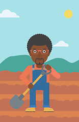 Image showing Farmer on the field with shovel.