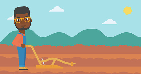 Image showing Farmer on the field with plough.