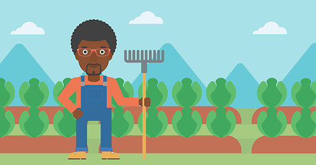 Image showing Farmer with rake.