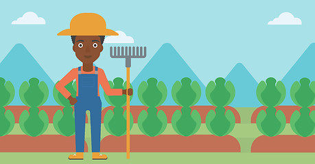 Image showing Farmer with rake.