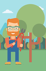 Image showing Farmer with pruner in garden.