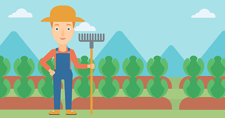 Image showing Farmer with rake.