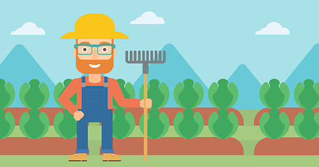 Image showing Farmer with rake.