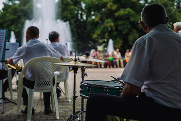 Image showing Men play musical instruments