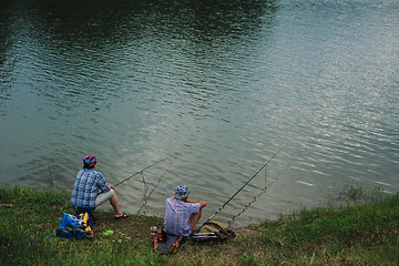 Image showing Couple catches fish with a fishing rod