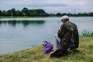 Image showing Man catches fish with a fishing rod