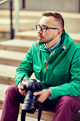 Image showing young hipster man with digital camera in city